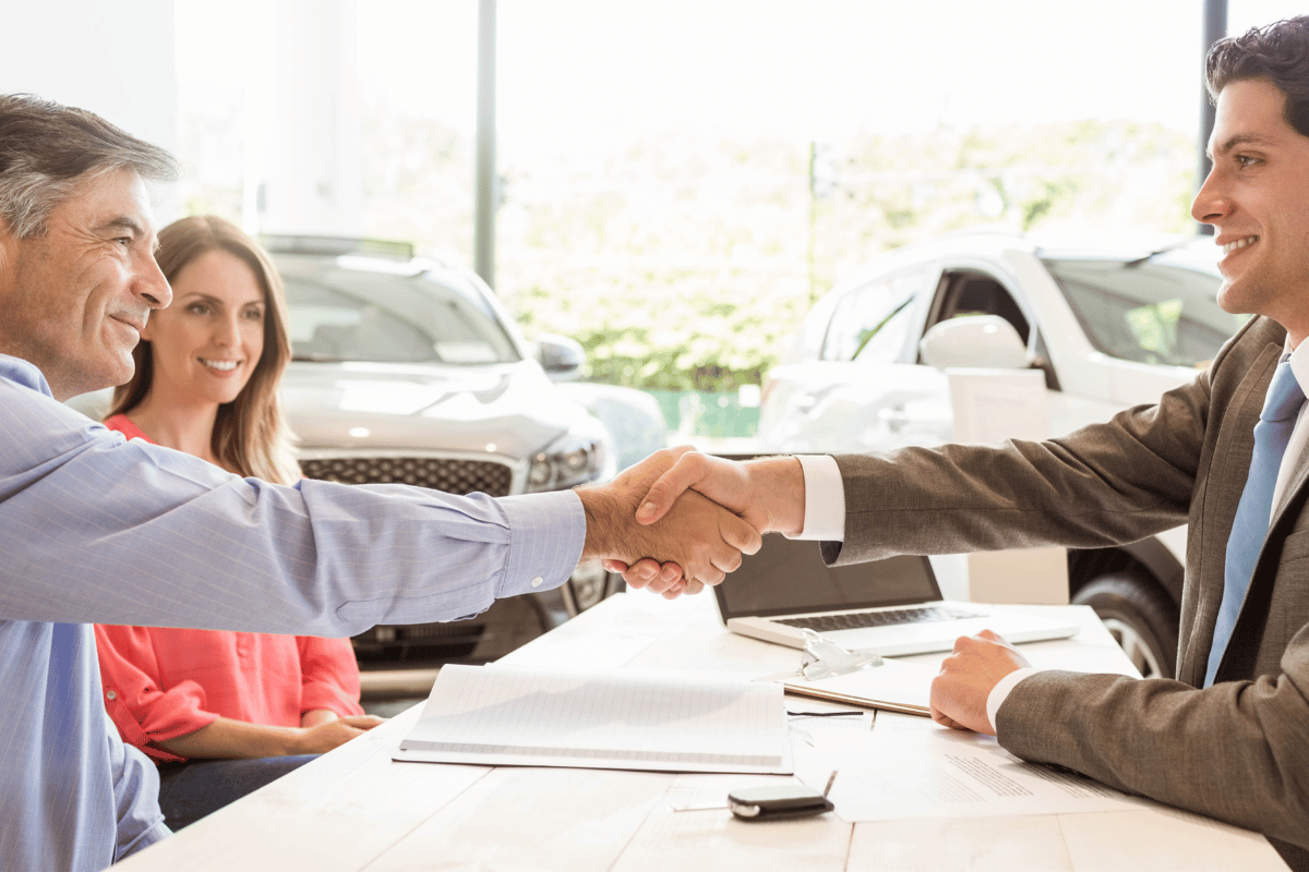 Sell my car in Surrey, customer and VMS Automotive dealer shaking hands after a fair car valuation
